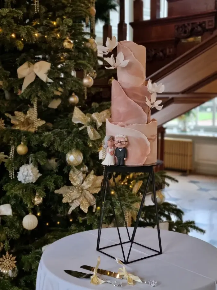 Modern marbled torn wrap effect 3 tier wedding cake with wafterpaper magnolia flowers