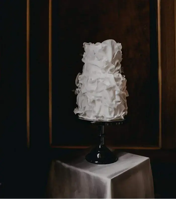 Silky soff white ruffle wedding cake at gosfield hall