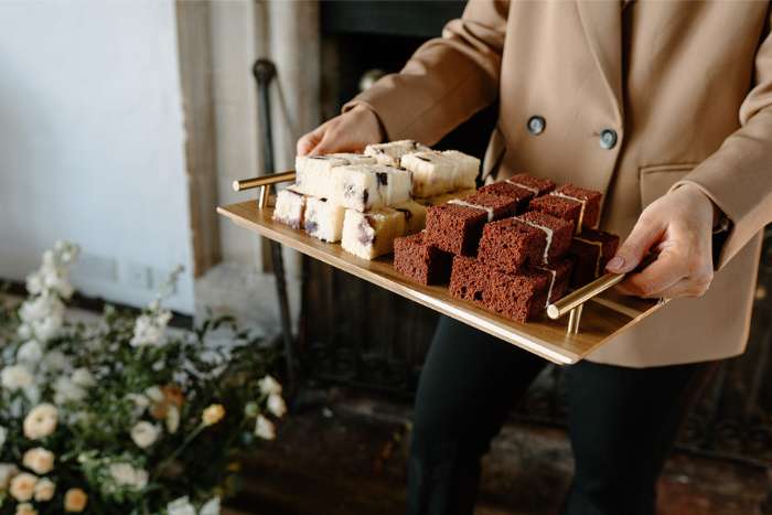 Serving tray of cut wedding cake slices, Butley Priory, Suffolk