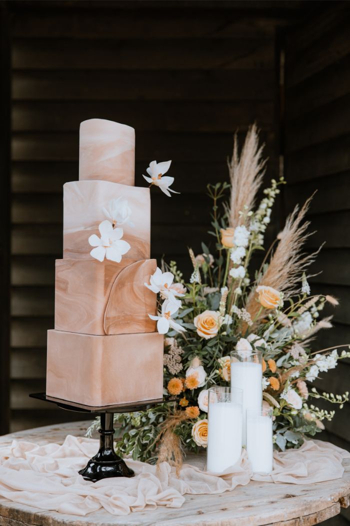 4 tier contemporary ombre wedding cake with repurposed floral display at hook house farm in Surrey