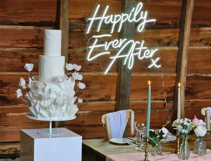 3 tier contemporary white wedding cake, surrey White on white contemporary ruffled wedding cake set in a modern barn in Surrey