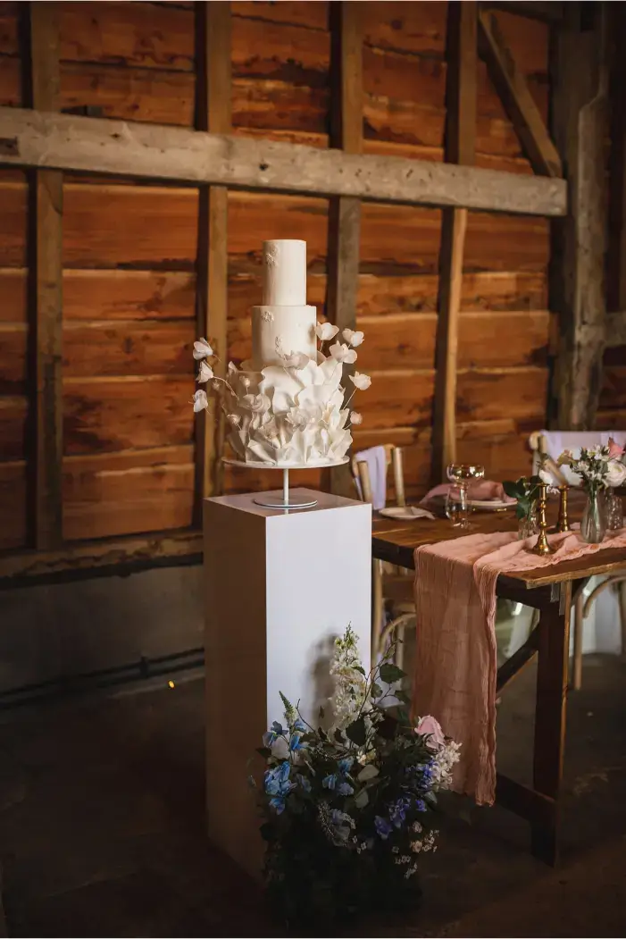 Contemporary white ruffle wedding cake with texture and abstract rose design Daniel Robinson Photography