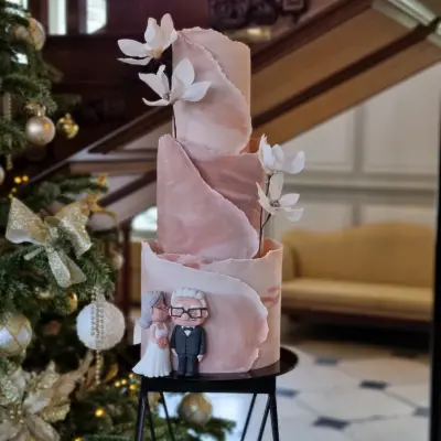 Neutral toned marbled and wrap effect contemporary wedding cake with wafer paper magnolias Gosfield hall Essex