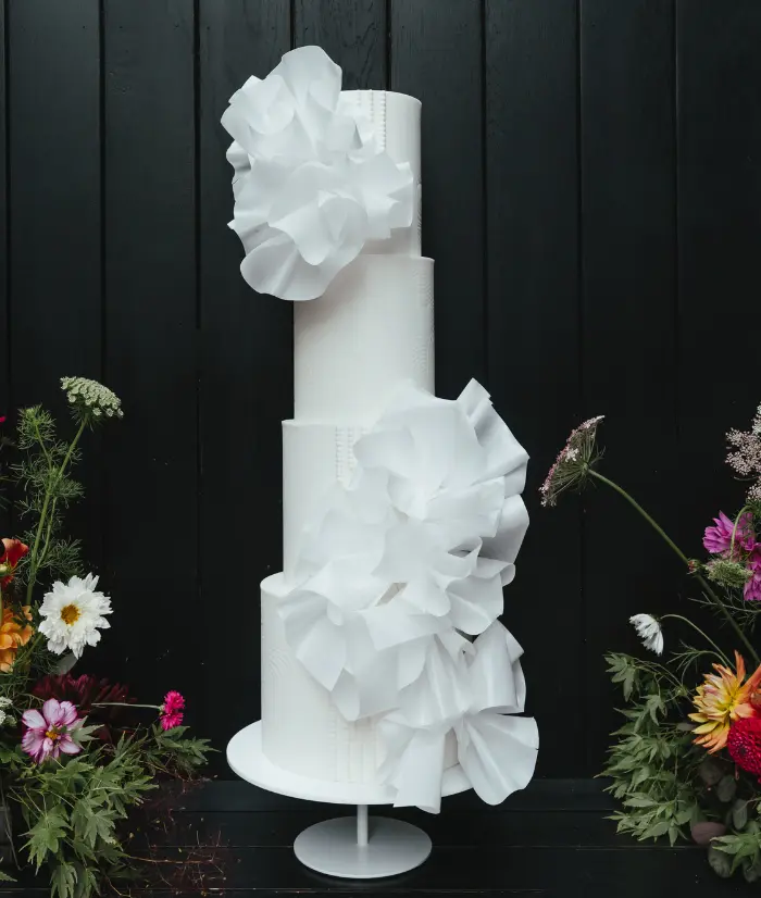 Contemporary pearls and ruffles 4 tier white wedding cake