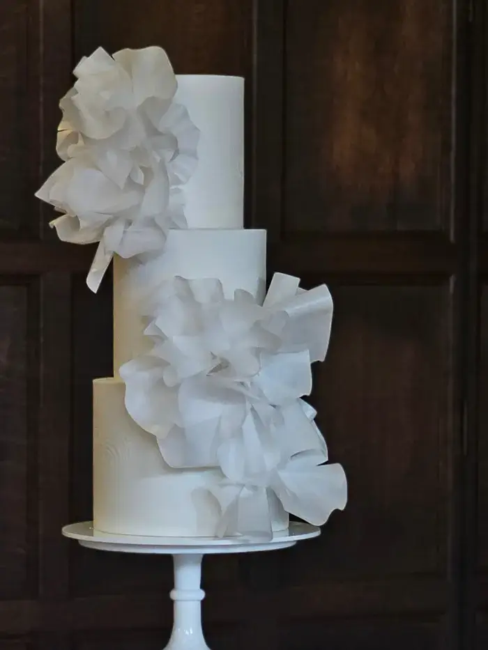 White 3 tier contemporary textured wedding cake with dramatic sculpted wafer paper ruffles Westminster College, Cambridge