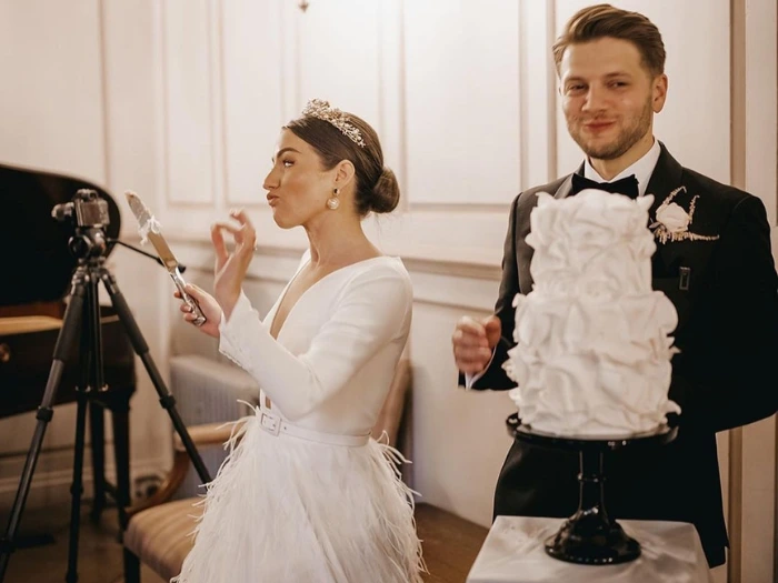 Wedding couple cutting their cake showing great appreciation for the taste and design