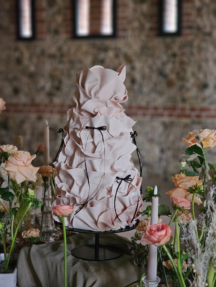 Mocha Mousse contemporary ruffle wedding cake with black bow ribbon detail at Tuffon  Hall Vineyards Essex