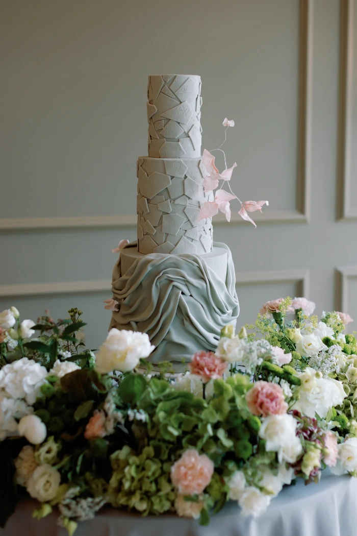 Broken ceramic style textured 3 tier wedding cake with contemporary draping at The Marquis, Suffolk