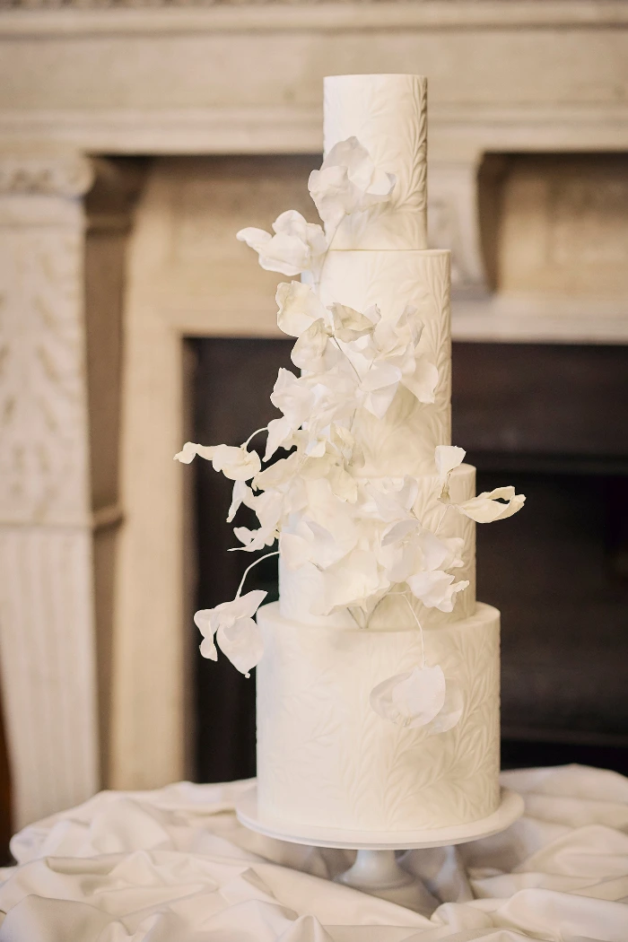 Stunning leaf textured white 4 tier wedding cake with abstract wafer paper flowers at The Royal Horseguards Hotel London