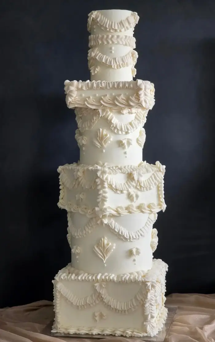 A mix of abstract and traditional royal icing piped 5 tier wedding cake at Hotel Cafe Royal, London