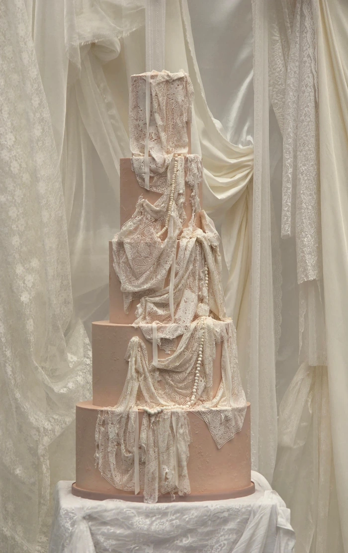 Lace pearls and ribbon draped large 5 tier neutral colour wedding cake at The Business Centre Islington, London