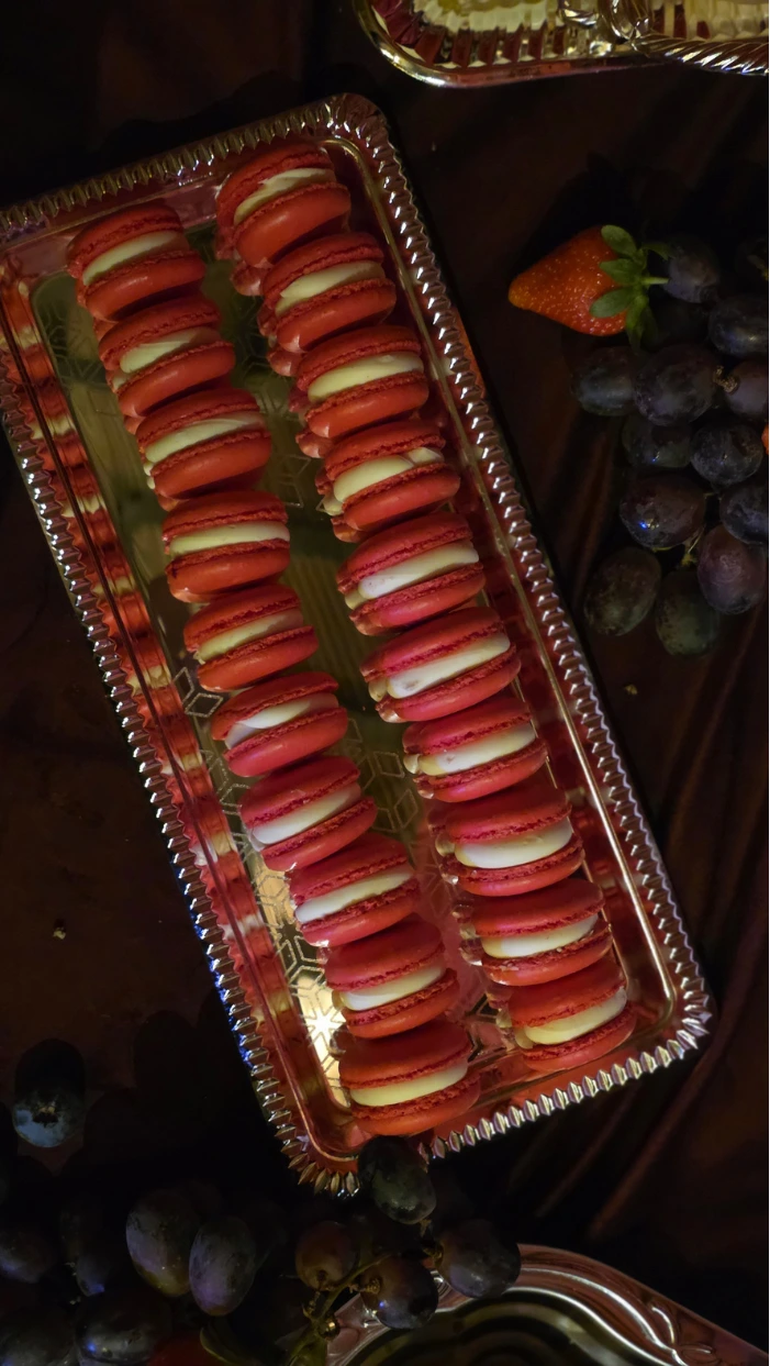 French macarons, displayed on vintage silver tray as part of a wedding dessert table at the Wilderness Reserve, Suffolk.