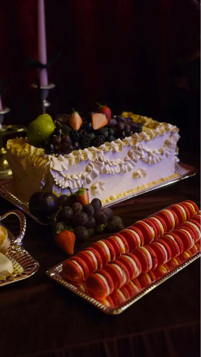 Buttercream piped long cake topped with fresh fruit as part of a wedding dessert table at Wilderness Reserve, Suffolk