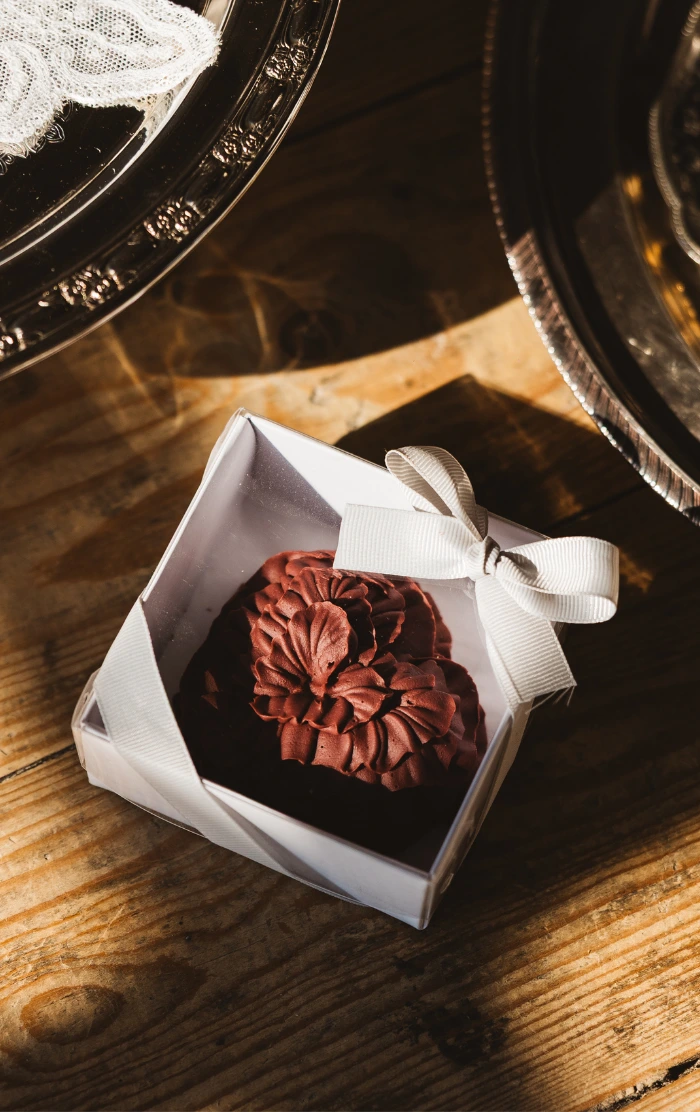 Rich burgundy luxury chocolate ruffle design wedding favours at The Barn on Botley Hill, Surrey
