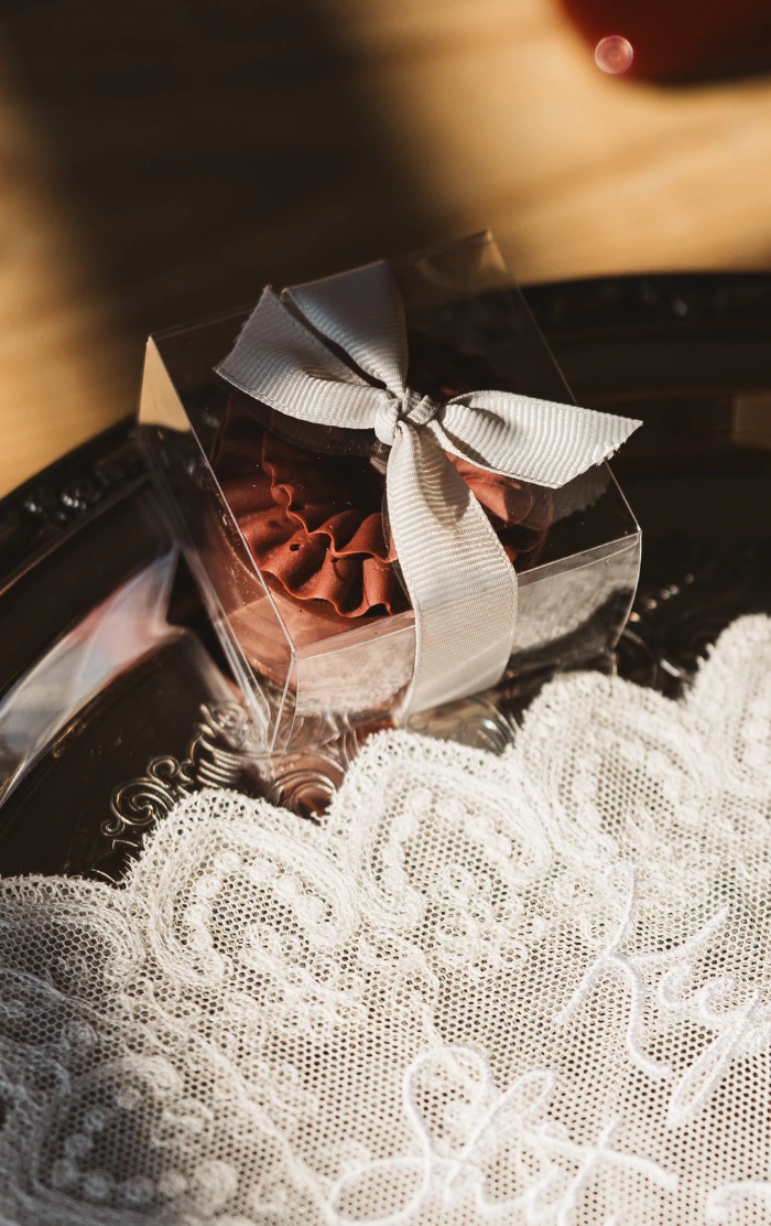 Rich burgundy Belgian milk chocolate covered Oreo topped with a unique ruffle design, in a clear gift box, tied with silver ribbon at The Barn on Botley Hill, Surrey